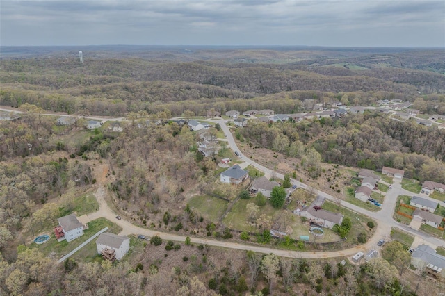 birds eye view of property with a residential view and a wooded view