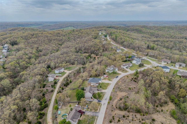 birds eye view of property featuring a view of trees and a residential view