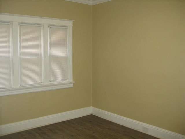 empty room with dark wood-type flooring and baseboards