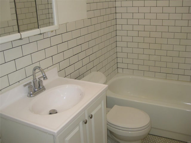bathroom with tile patterned flooring, vanity, tile walls, and toilet