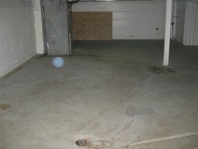 unfinished basement featuring heating unit