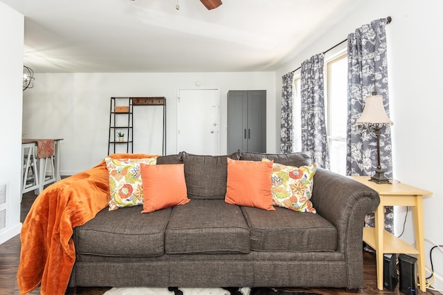 living area with a ceiling fan and wood finished floors