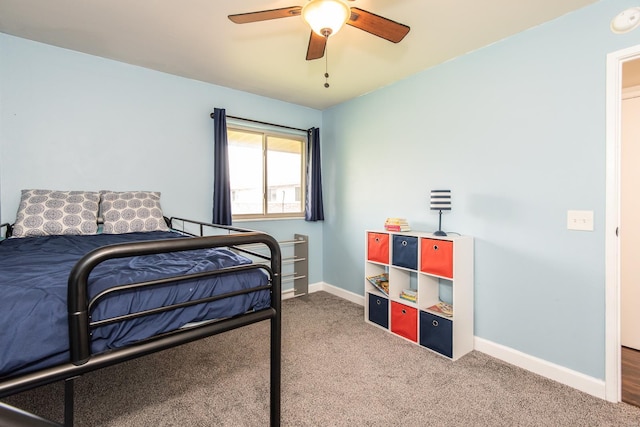 bedroom featuring baseboards, ceiling fan, and carpet
