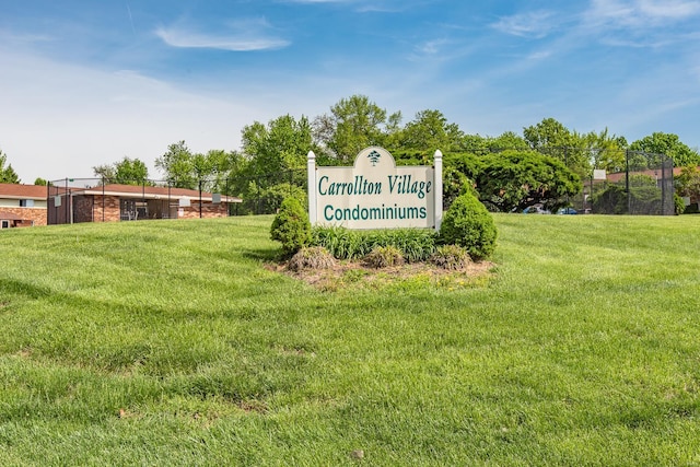 community / neighborhood sign with a yard