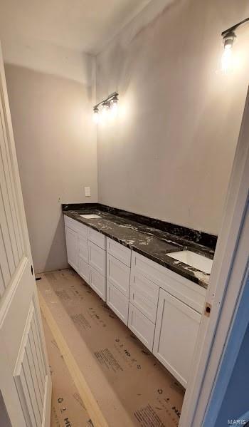 bathroom featuring double vanity and a sink