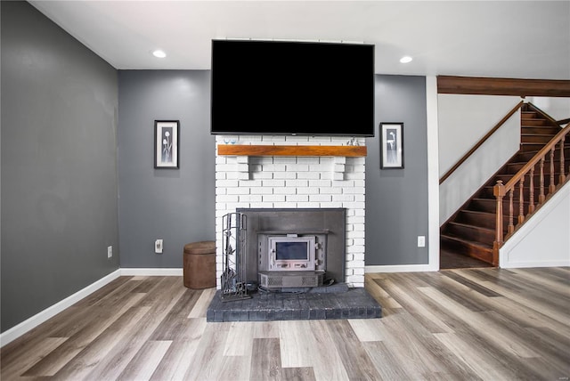 unfurnished living room with baseboards, recessed lighting, wood finished floors, and stairs