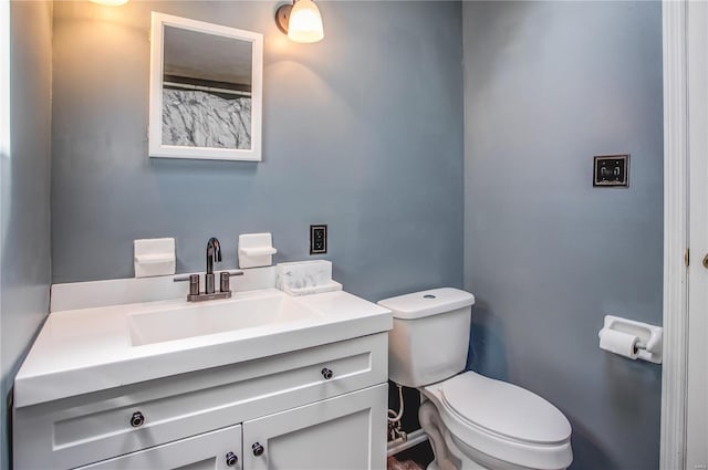 full bath featuring toilet and vanity