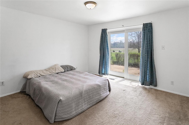 carpeted bedroom featuring access to exterior and baseboards