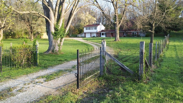 view of gate featuring a yard and fence