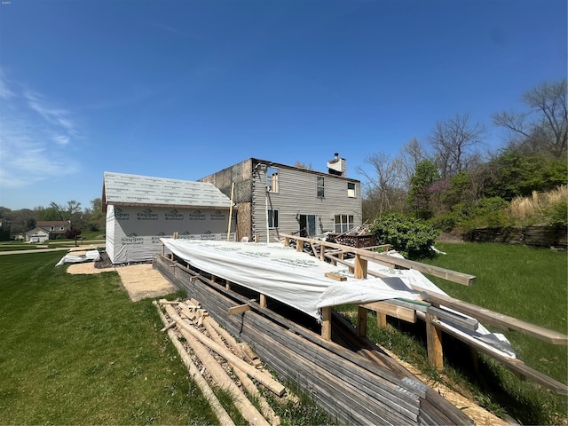 rear view of property with a lawn and a chimney