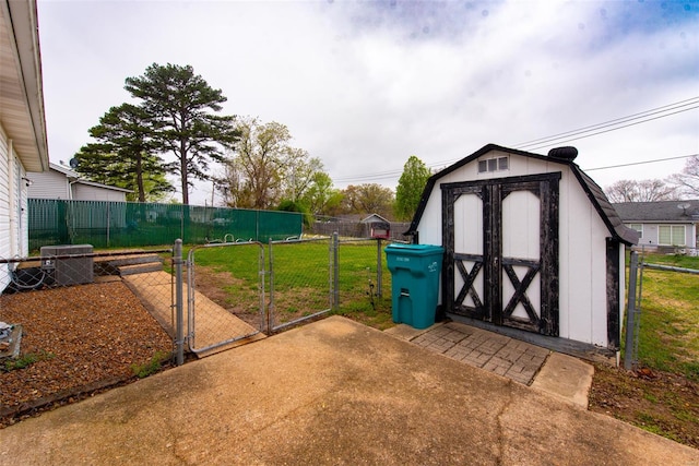 view of shed with fence, cooling unit, and a gate