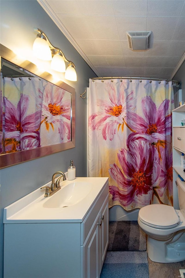 full bathroom with toilet, crown molding, vanity, and visible vents