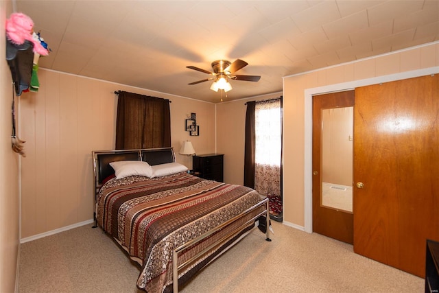 bedroom featuring baseboards, ceiling fan, and carpet