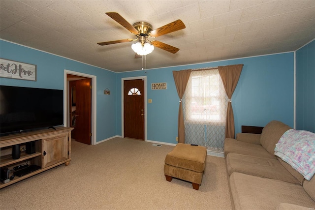 carpeted living area with baseboards and a ceiling fan