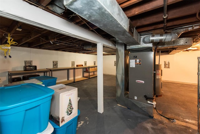 unfinished basement featuring electric water heater and heating unit