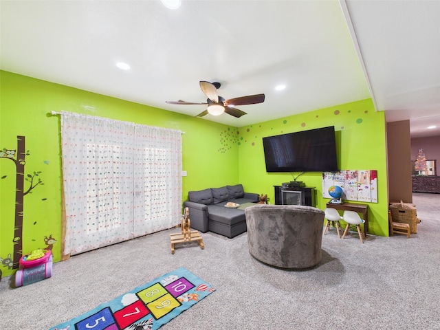 carpeted living area with a ceiling fan and recessed lighting