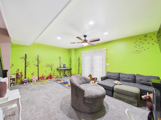 carpeted living room with ceiling fan and recessed lighting