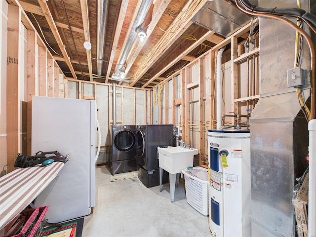 unfinished basement featuring water heater, separate washer and dryer, a sink, and freestanding refrigerator