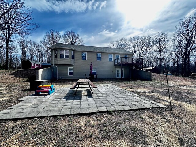 rear view of property with a patio and a deck