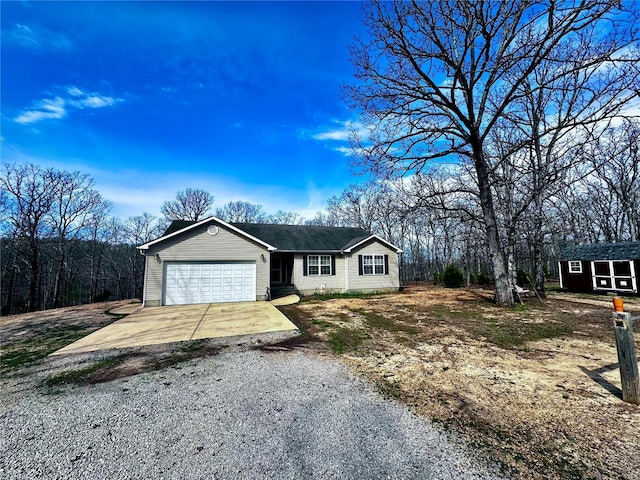 ranch-style home with driveway and an attached garage