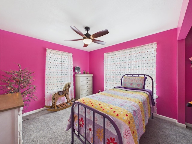 bedroom featuring baseboards, ceiling fan, and carpet