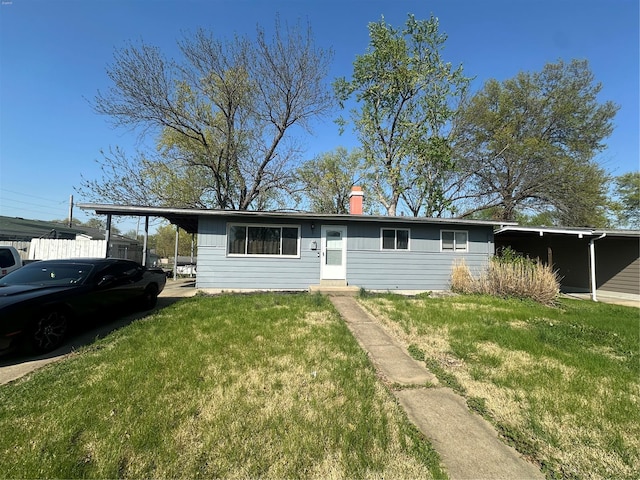 single story home featuring a front lawn, a chimney, and entry steps