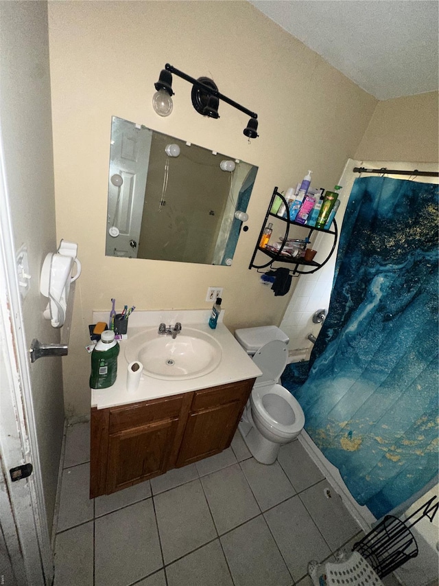 bathroom with tile patterned flooring, toilet, and vanity