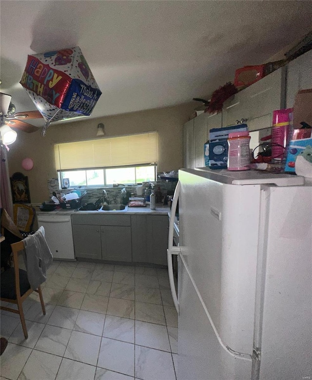 interior space with a sink, ceiling fan, and marble finish floor