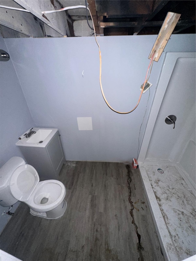 full bathroom with walk in shower, wood finished floors, and toilet