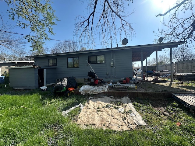 back of property with fence and a patio