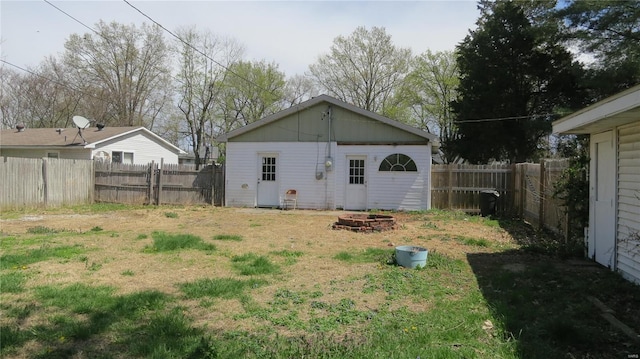 back of property with a yard and a fenced backyard