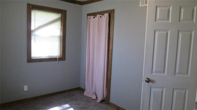 unfurnished bedroom with visible vents, baseboards, and carpet flooring