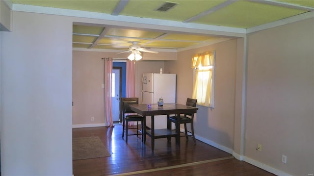 dining space with visible vents, baseboards, ceiling fan, and wood finished floors