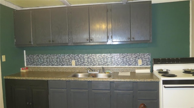 kitchen with tasteful backsplash, electric stove, a sink, and gray cabinets