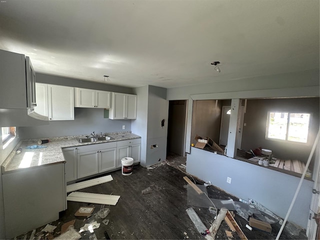 kitchen featuring a sink, white cabinets, and dark wood finished floors