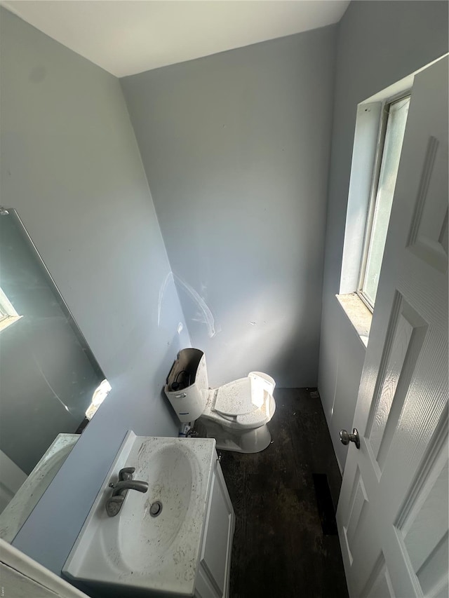 half bathroom with vanity and toilet