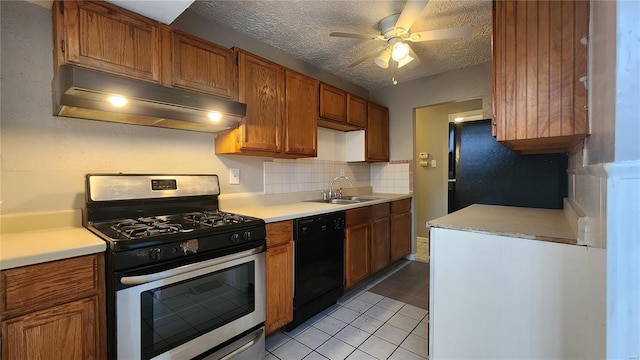 kitchen with light tile patterned floors, black appliances, under cabinet range hood, light countertops, and a sink