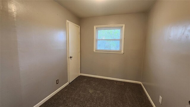 carpeted empty room with visible vents and baseboards
