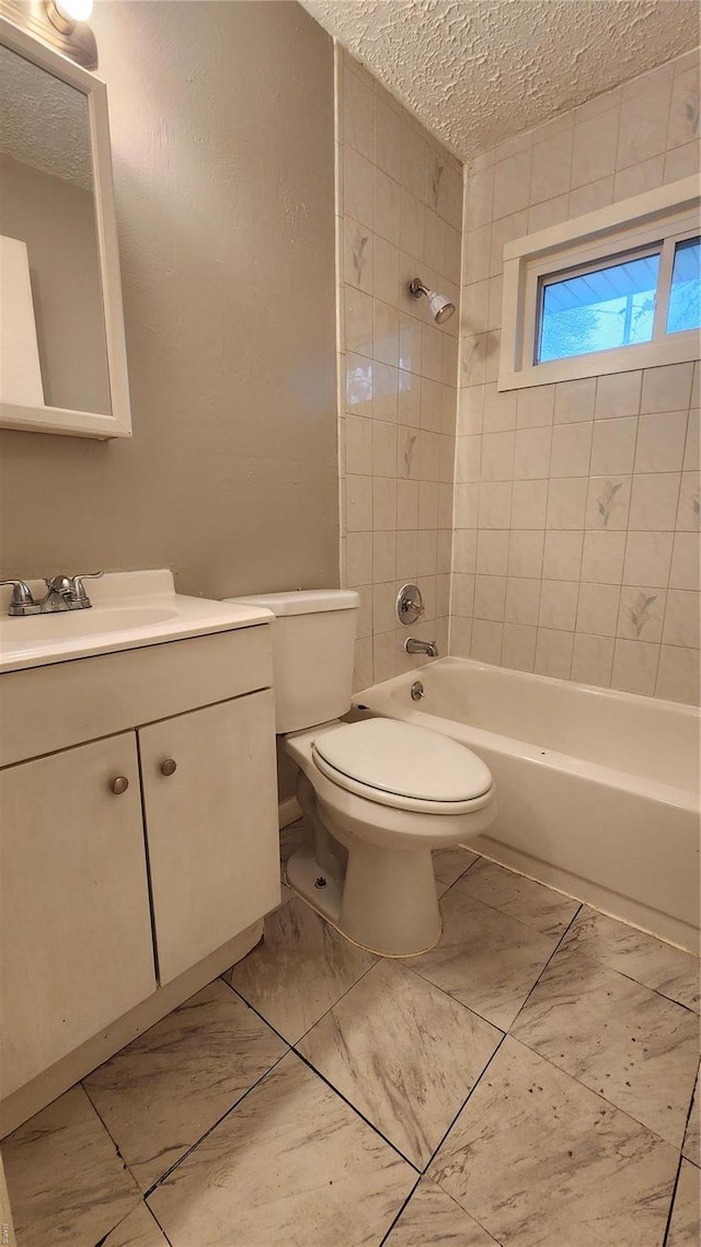 full bathroom featuring bathing tub / shower combination, a textured ceiling, vanity, toilet, and marble finish floor