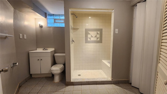 full bath featuring toilet, vanity, baseboards, and a shower stall