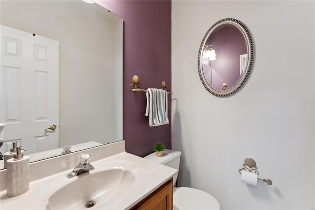 half bathroom featuring toilet and vanity