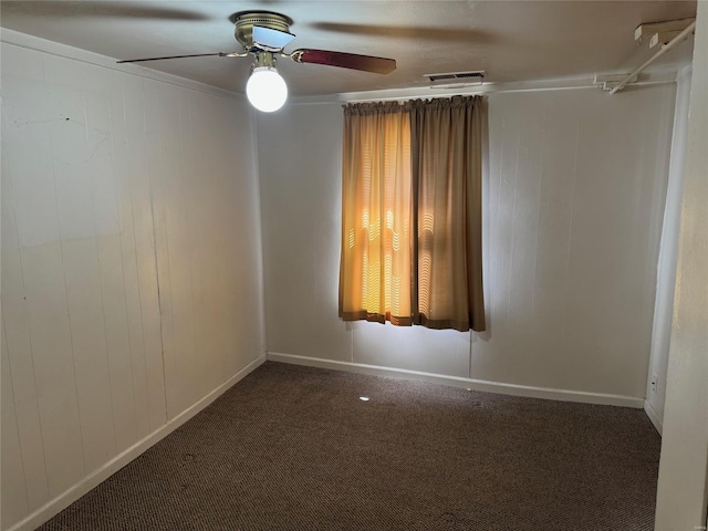 carpeted empty room with visible vents, ceiling fan, and baseboards