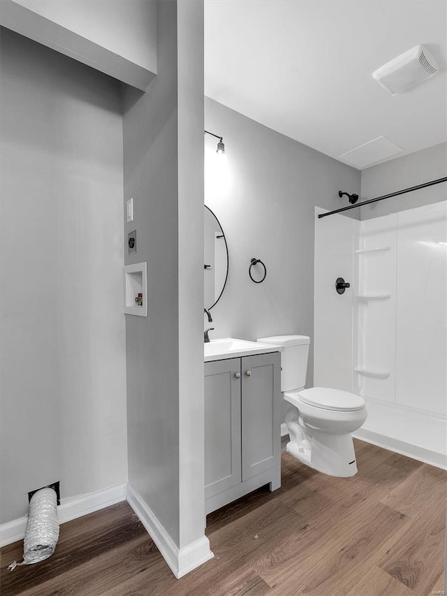 bathroom with walk in shower, wood finished floors, toilet, and visible vents