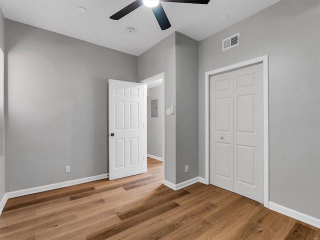 unfurnished bedroom with visible vents, ceiling fan, baseboards, a closet, and wood finished floors