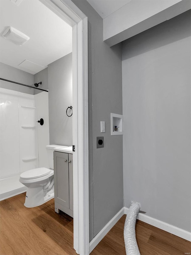 full bathroom with toilet, visible vents, a shower, and wood finished floors