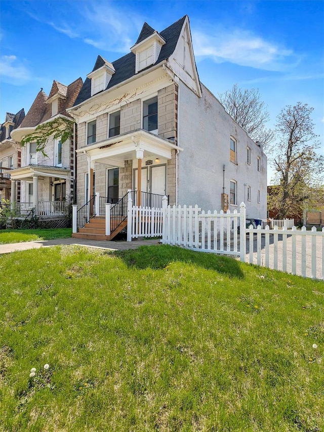 view of front of home with a porch, a front yard, a fenced front yard, and stone siding