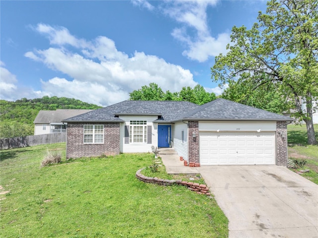 ranch-style home with concrete driveway, a front yard, fence, brick siding, and a garage