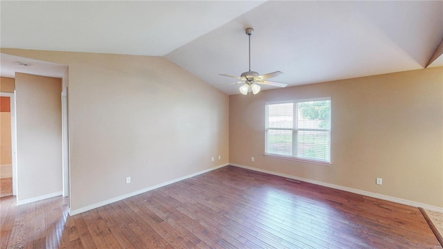 spare room with baseboards, wood finished floors, a ceiling fan, and lofted ceiling
