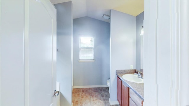 bathroom with lofted ceiling, visible vents, baseboards, toilet, and vanity