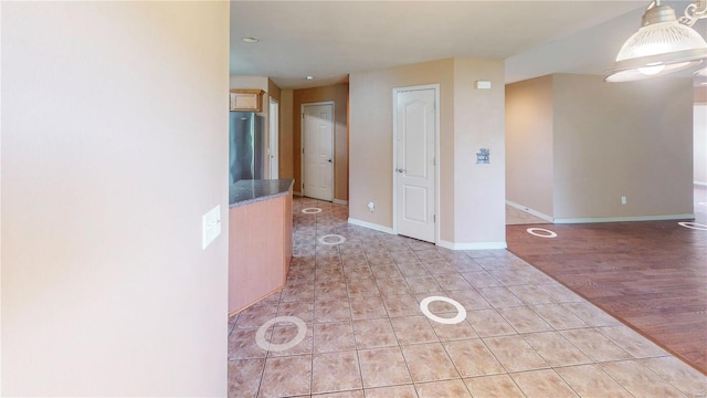 empty room featuring recessed lighting, light tile patterned flooring, and baseboards
